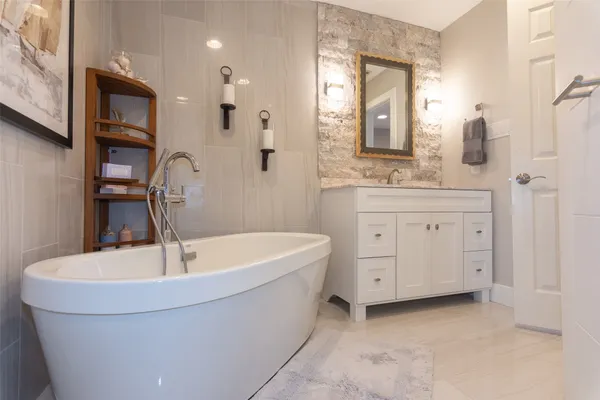 a bathroom with a bathtub and a sink