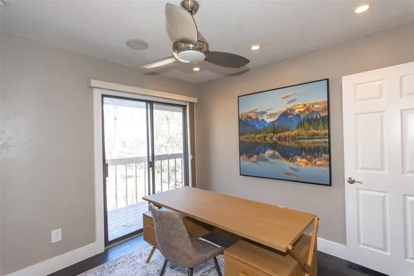a view of a livingroom with furniture wooden floor and a ceiling fan