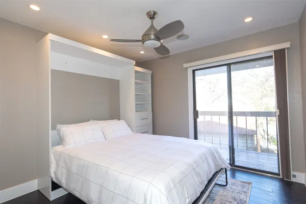 a bedroom with a large bed and a large window