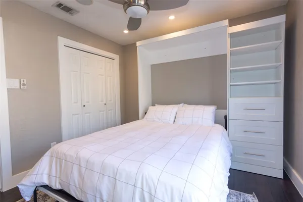 a bedroom with a bed and a ceiling fan