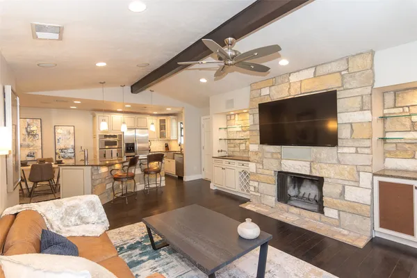 a living room with fireplace furniture and a flat screen tv