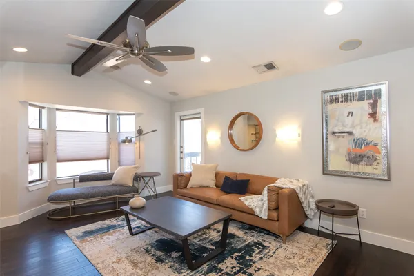 a living room with furniture a window and a chandelier
