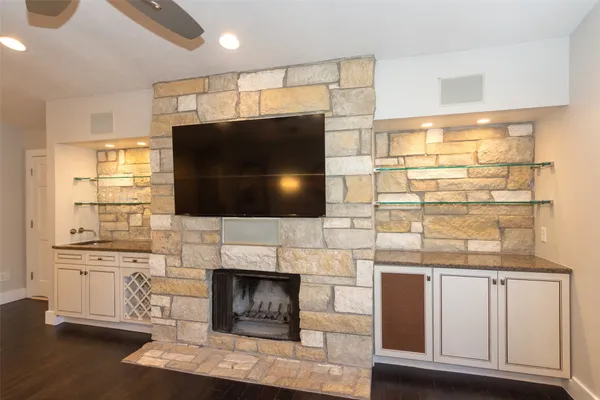 a living room with furniture a flat screen tv and a fireplace