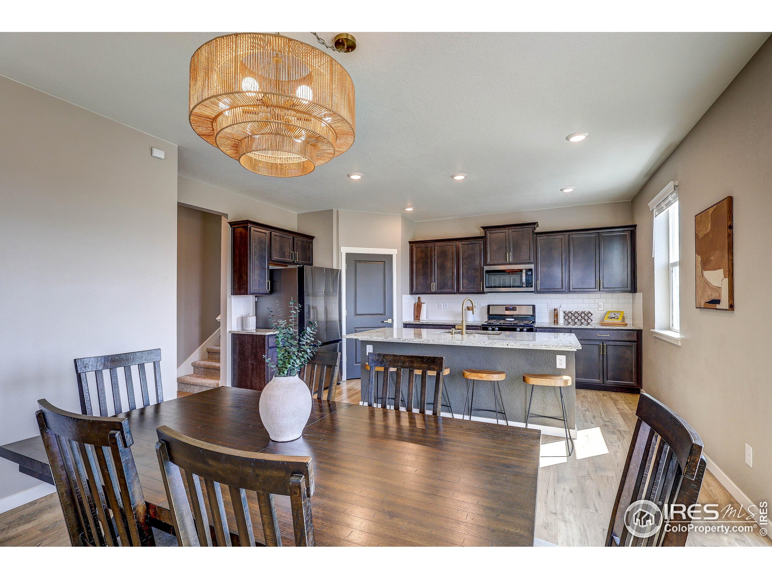 1335 Copeland Falls Road Severance, CO 80550 - Photo 14 of 40 a kitchen with a dining table chairs and view living room