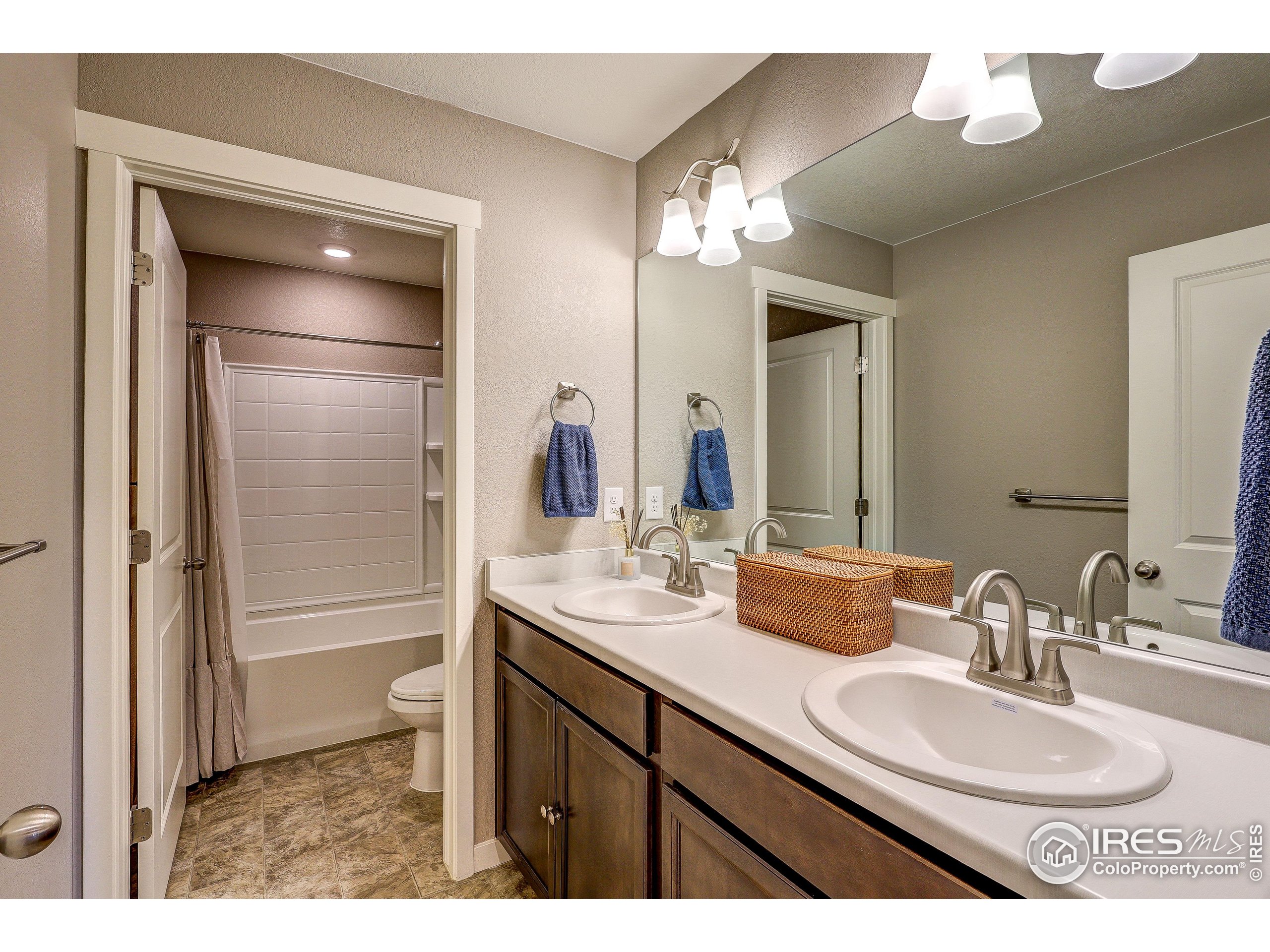 1335 Copeland Falls Road Severance, CO 80550 - Photo 24 of 40 a bathroom with a sink a light fixture and a mirror
