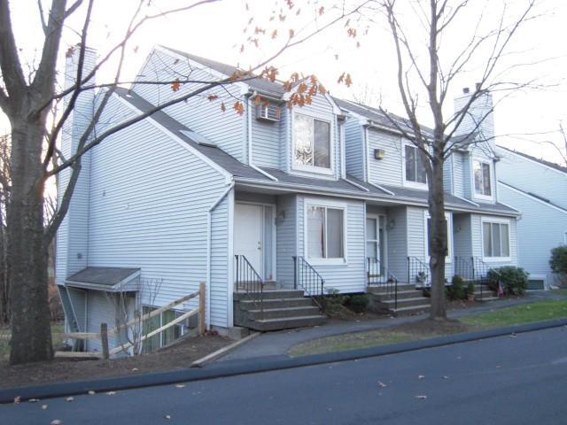 20 East Pembroke Road, Unit 39 Danbury, CT 06811 - Photo 1 of 1 a view of a white house with a large tree