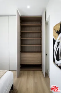 a bathroom with a double vanity sink toilet mirror and shower