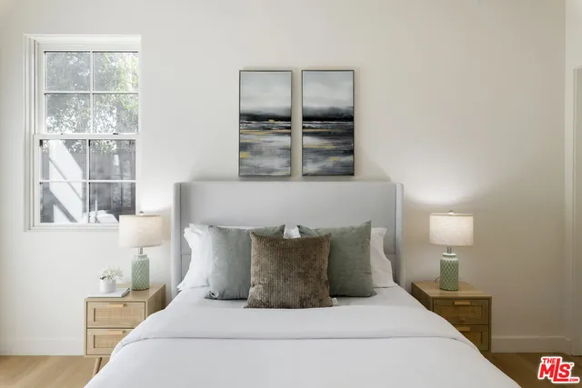 a living room with furniture potted plant and a painting on the wall