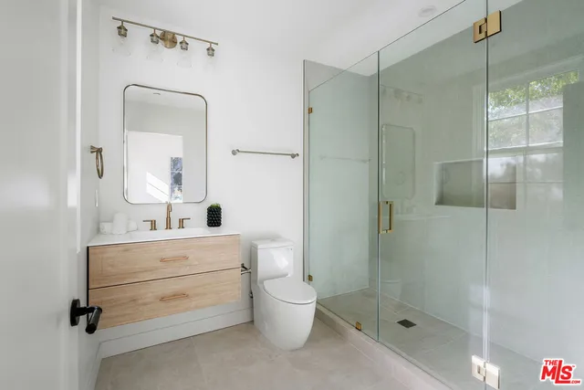 a living room with furniture potted plant and a wooden floor