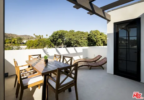 a view of a balcony with a palm tree