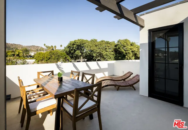 a view of a balcony with a palm tree