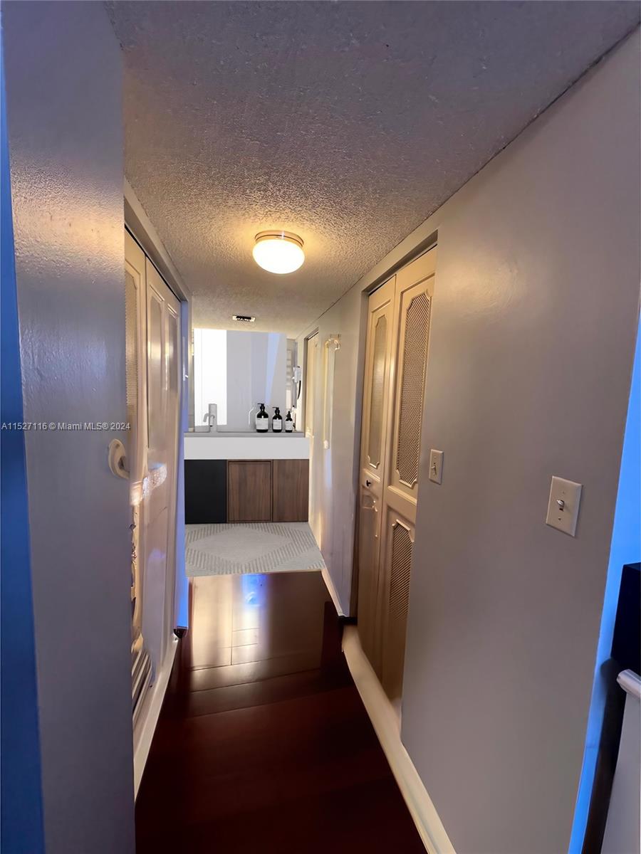 1665 Bay Road, Unit 425 Miami Beach, FL 33139 - Photo 16 of 29 a kitchen with stainless steel appliances a refrigerator and wooden floor