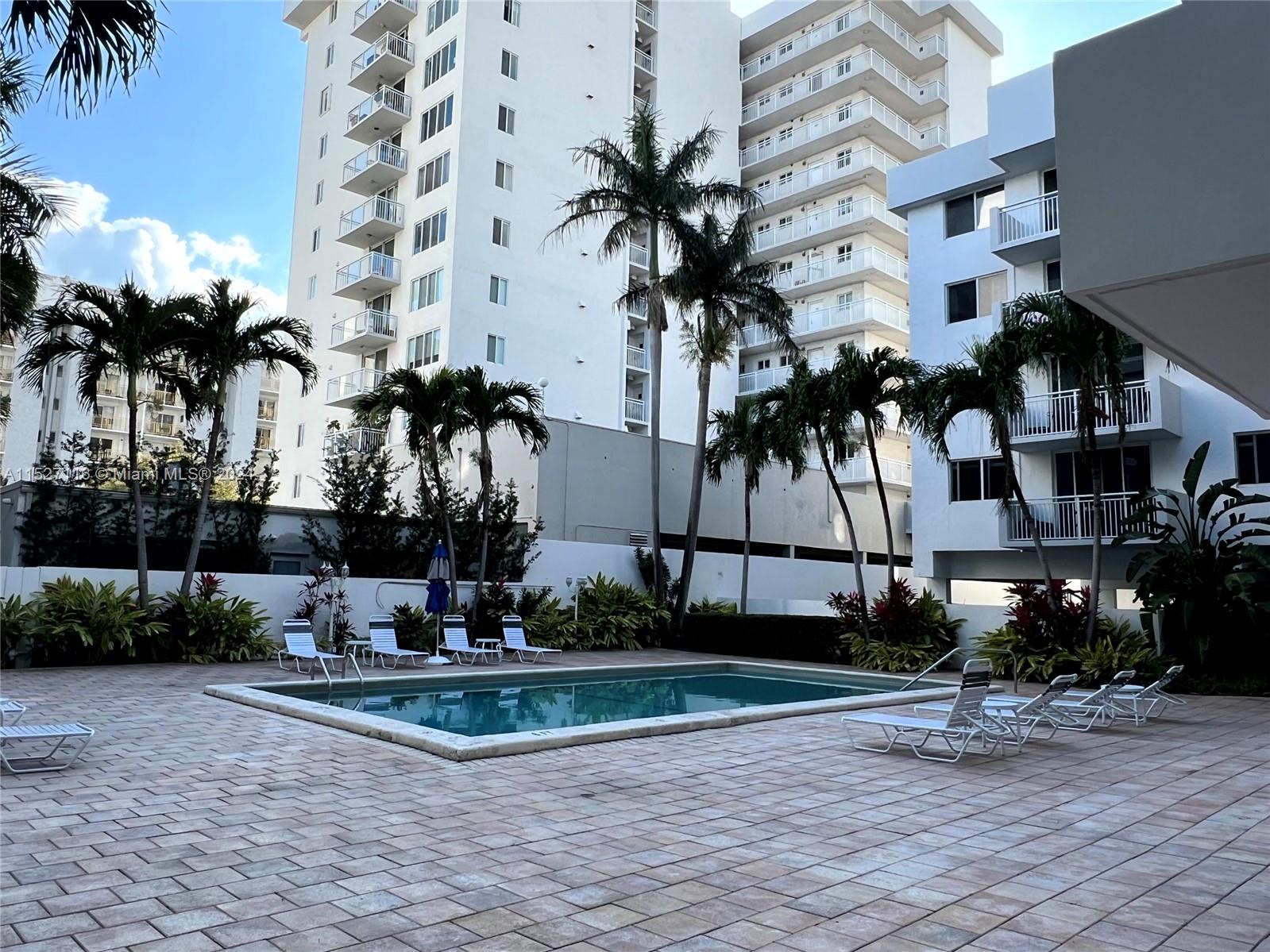 1665 Bay Road, Unit 425 Miami Beach, FL 33139 - Photo 2 of 29 a view of a backyard with a fountain