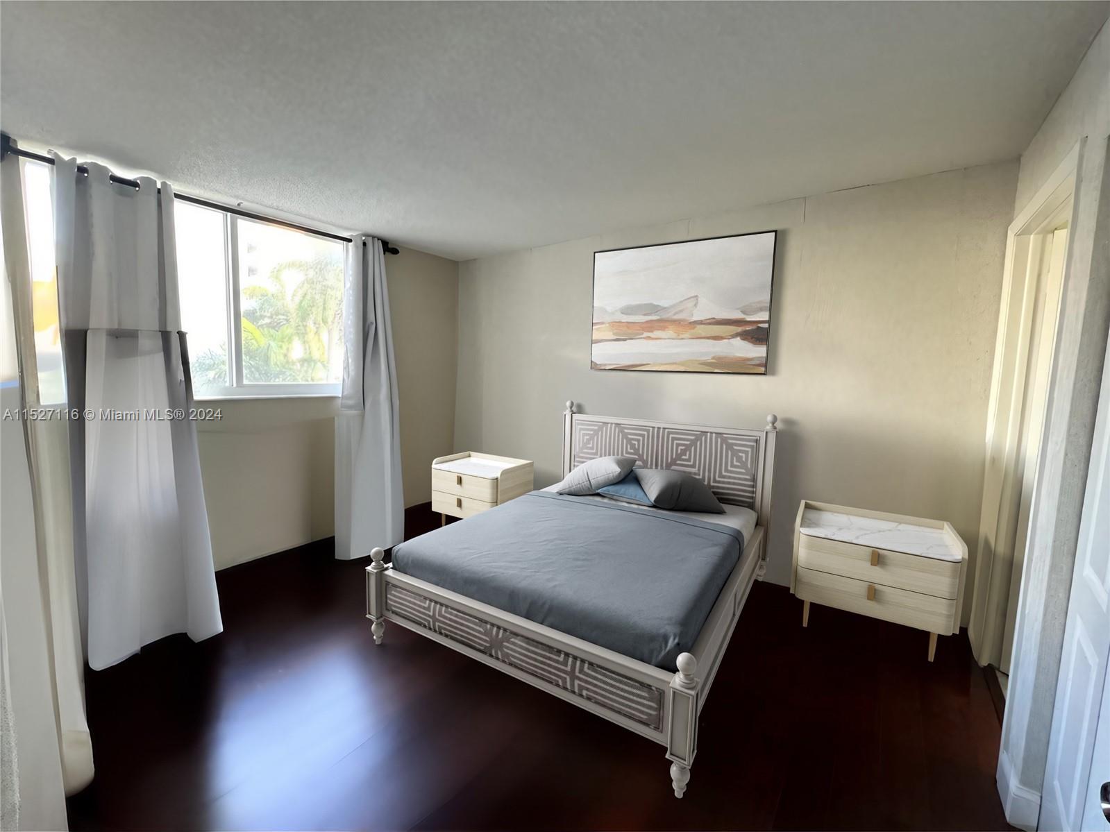 1665 Bay Road, Unit 425 Miami Beach, FL 33139 - Photo 22 of 29 a bedroom with a bed and wooden floor