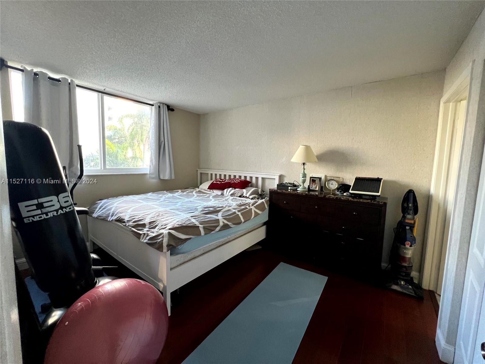 1665 Bay Road, Unit 425 Miami Beach, FL 33139 - Photo 23 of 29 a bedroom with a bed and dresser