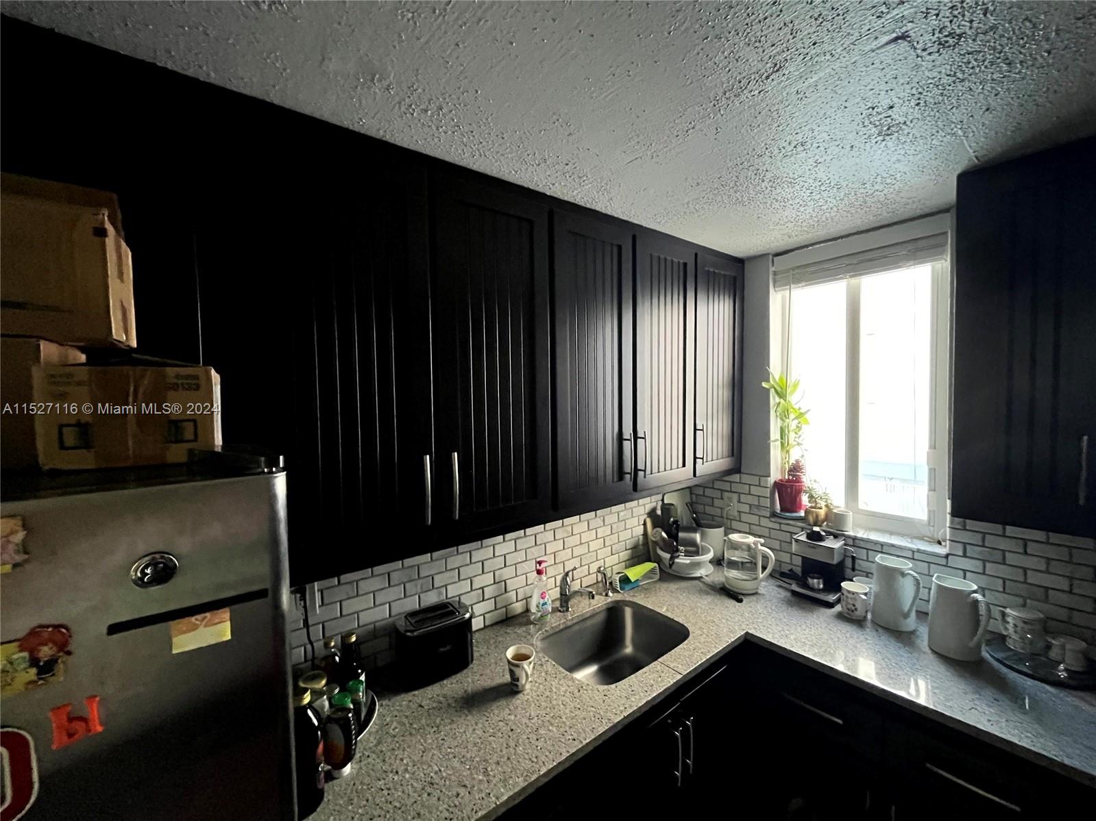 1665 Bay Road, Unit 425 Miami Beach, FL 33139 - Photo 26 of 29 a bathroom with a sink and a mirror