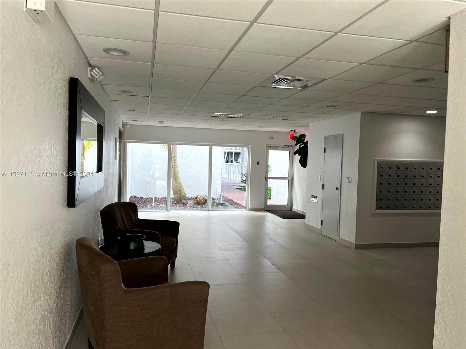 1665 Bay Road, Unit 425 Miami Beach, FL 33139 - Photo 8 of 29 a living room with furniture and a flat screen tv