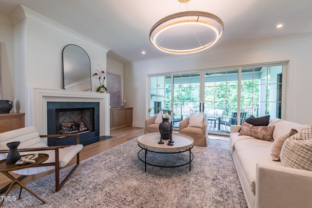 a kitchen with stainless steel appliances a dining table chairs and wooden floor