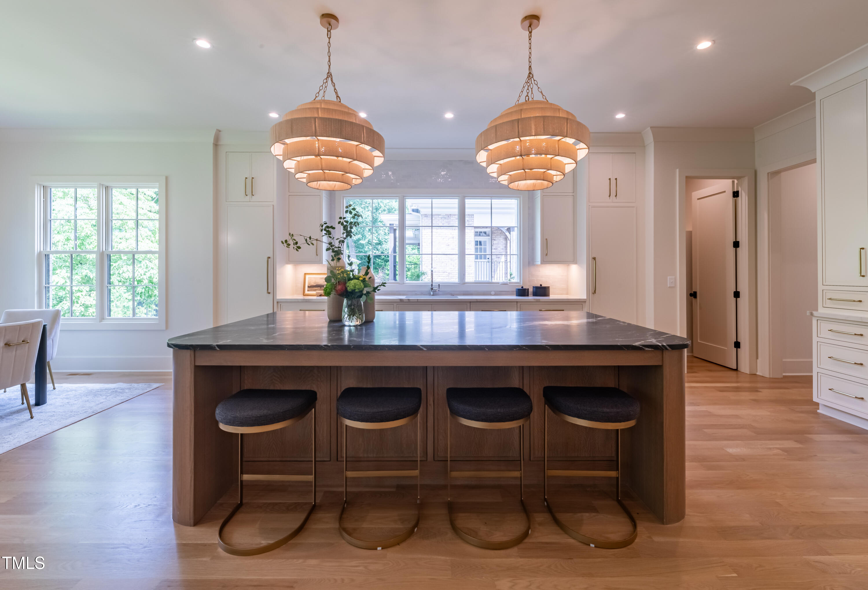 2227 Wheeler Road Raleigh, NC 27607 - Photo 15 of 56 a kitchen with a wooden floor and a chandelier