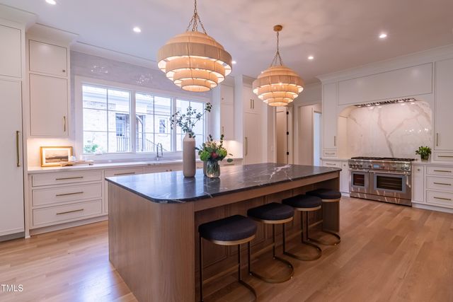 a large kitchen with stainless steel appliances a large island in the center