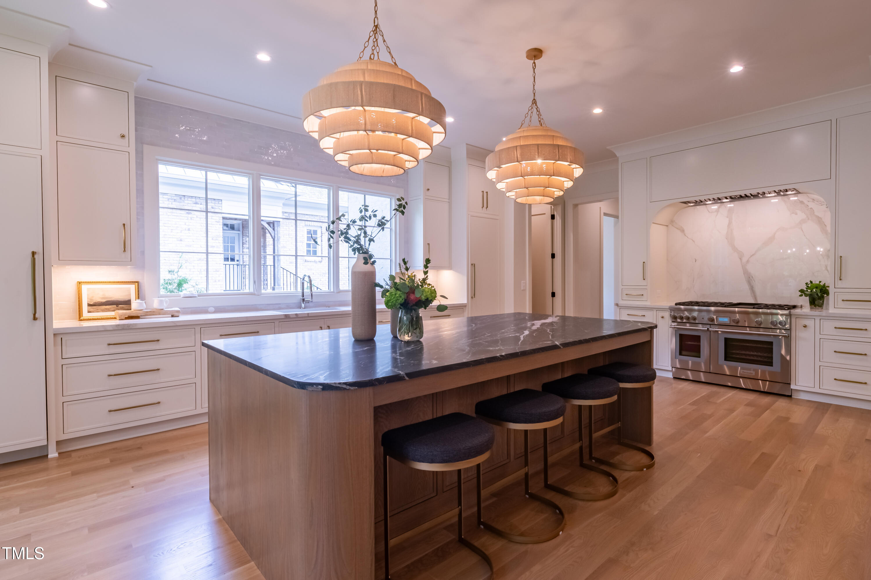 2227 Wheeler Road Raleigh, NC 27607 - Photo 16 of 56 a kitchen with stainless steel appliances a dining table chairs and wooden floor