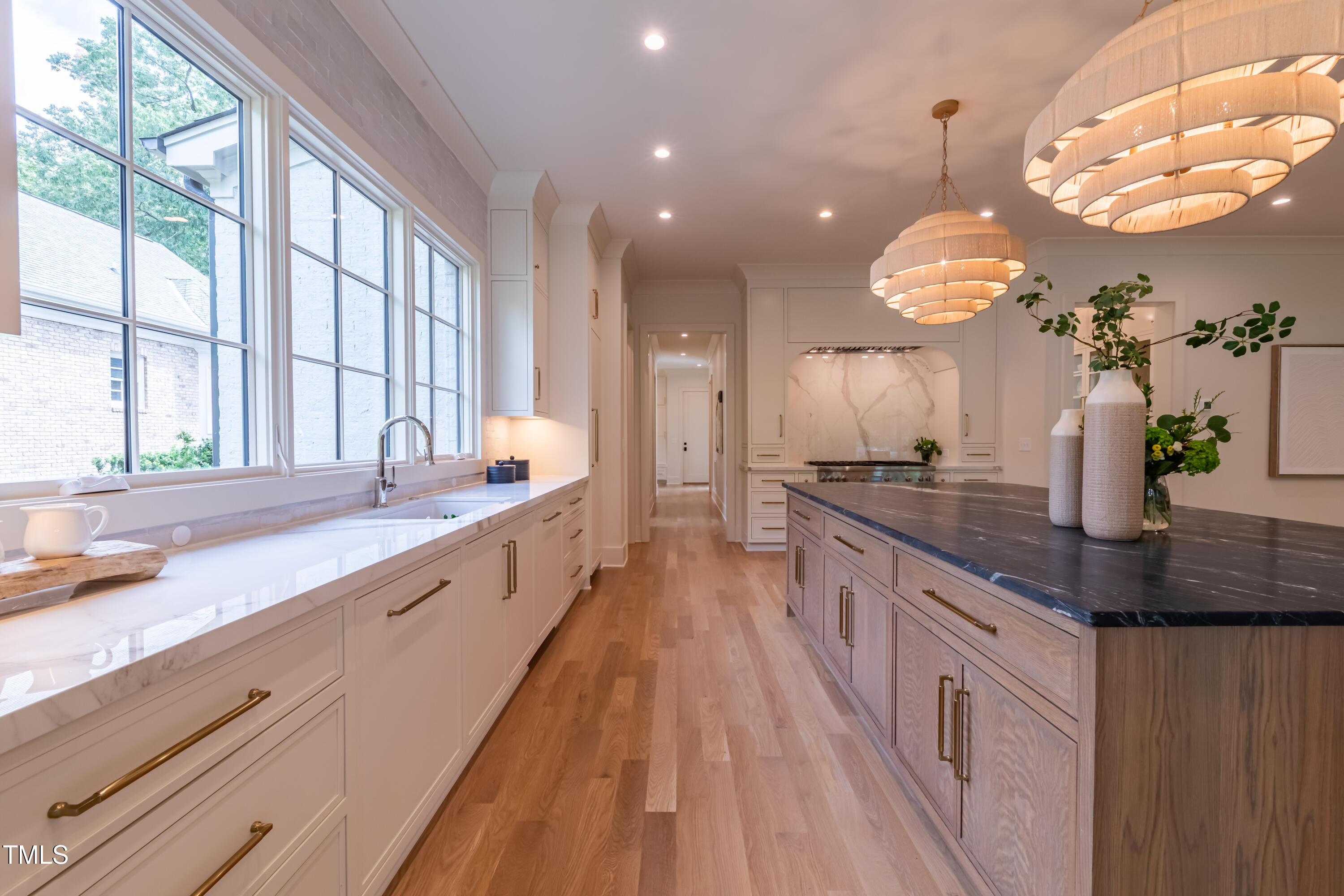2227 Wheeler Road Raleigh, NC 27607 - Photo 18 of 56 a large kitchen with granite countertop a large counter top a sink a window and stainless steel appliances