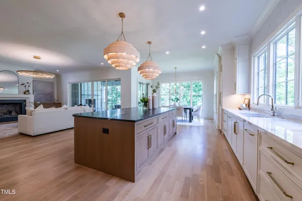 a large kitchen with kitchen island granite countertop a large center island attached withe living room