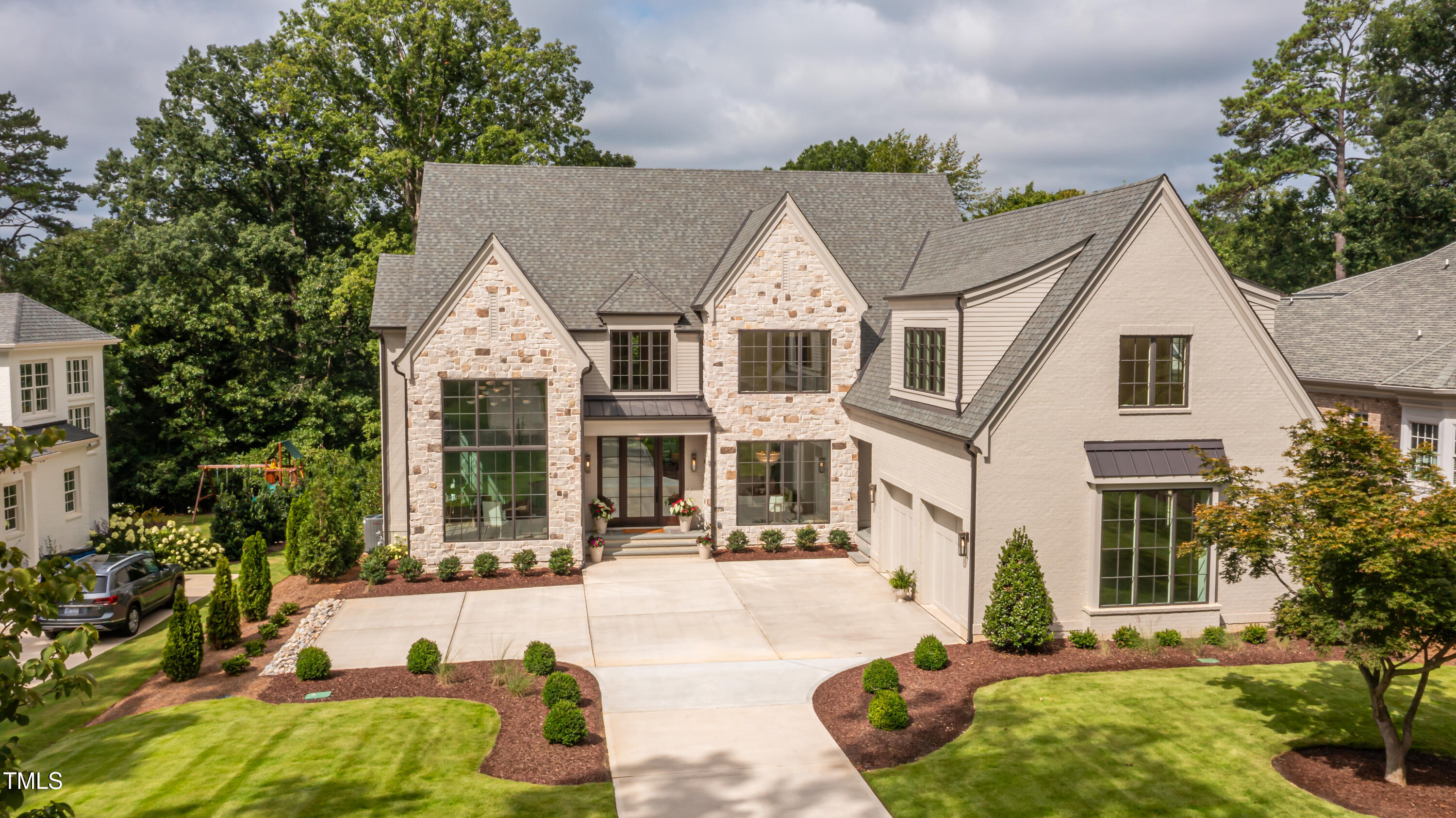2227 Wheeler Road Raleigh, NC 27607 - Photo 2 of 56 a view of a white house with a swimming pool and lawn chairs with plants