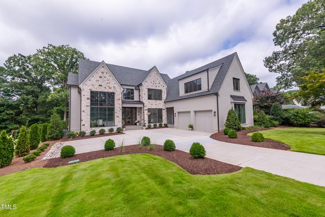 a view of a house with a yard and sitting area