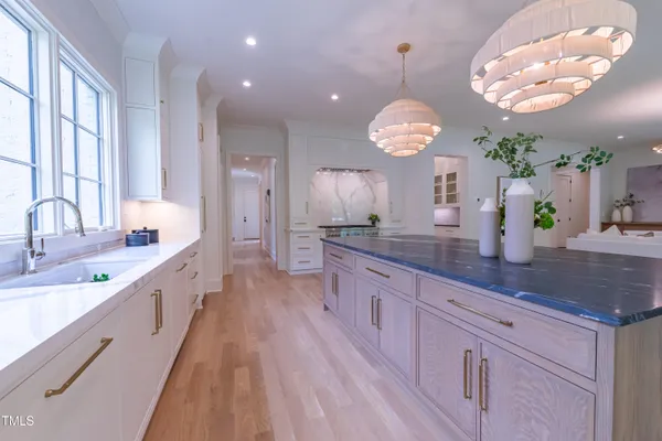 a kitchen with stainless steel appliances a stove and a wooden floor