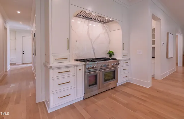 a kitchen with stainless steel appliances a large counter top