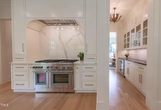 a kitchen with stainless steel appliances a refrigerator and cabinets
