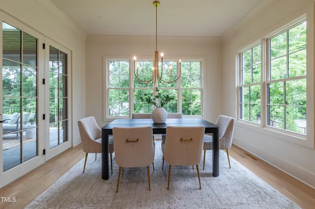 a dining room with furniture and a potted plant