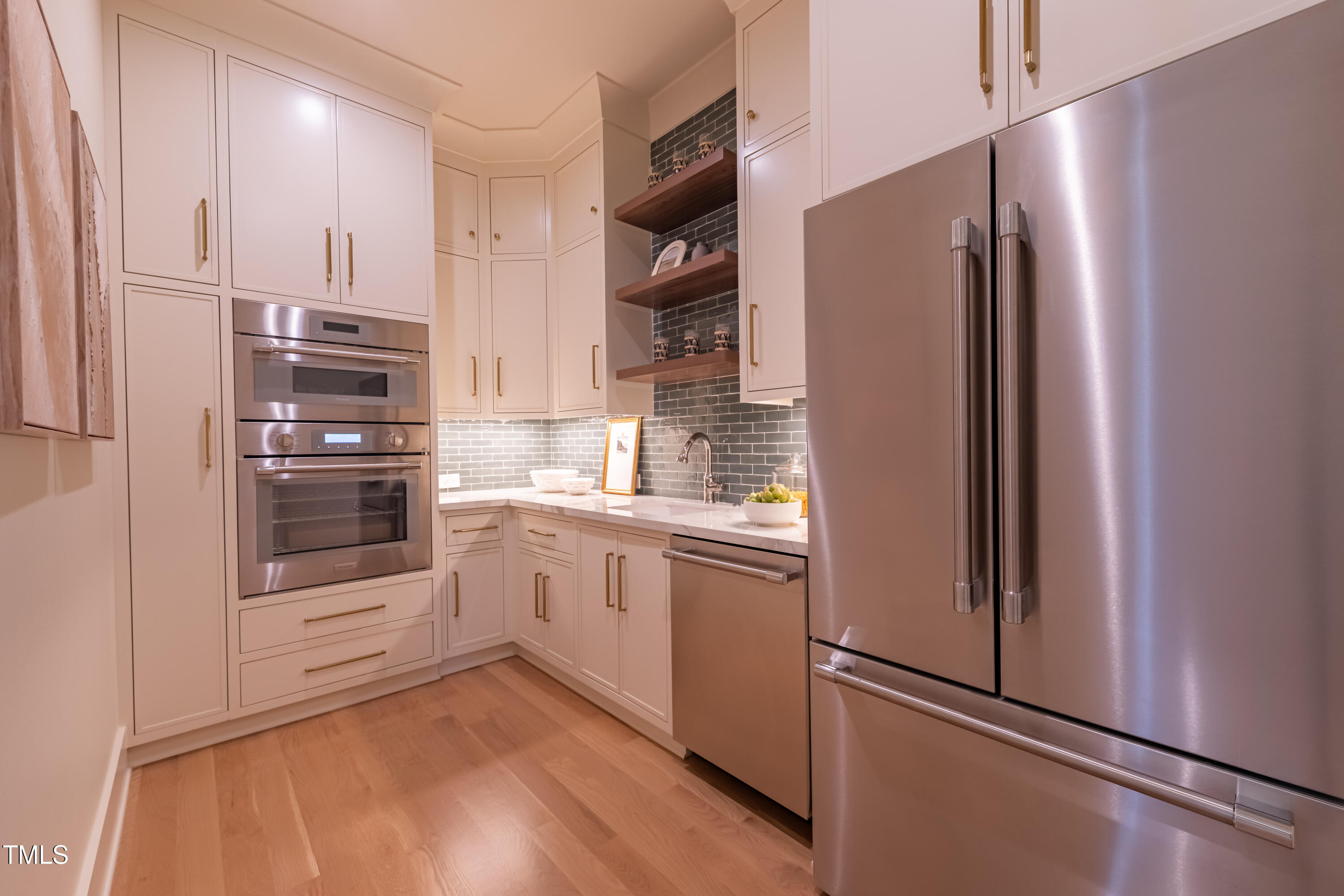2227 Wheeler Road Raleigh, NC 27607 - Photo 28 of 56 a kitchen with stainless steel appliances a refrigerator and cabinets