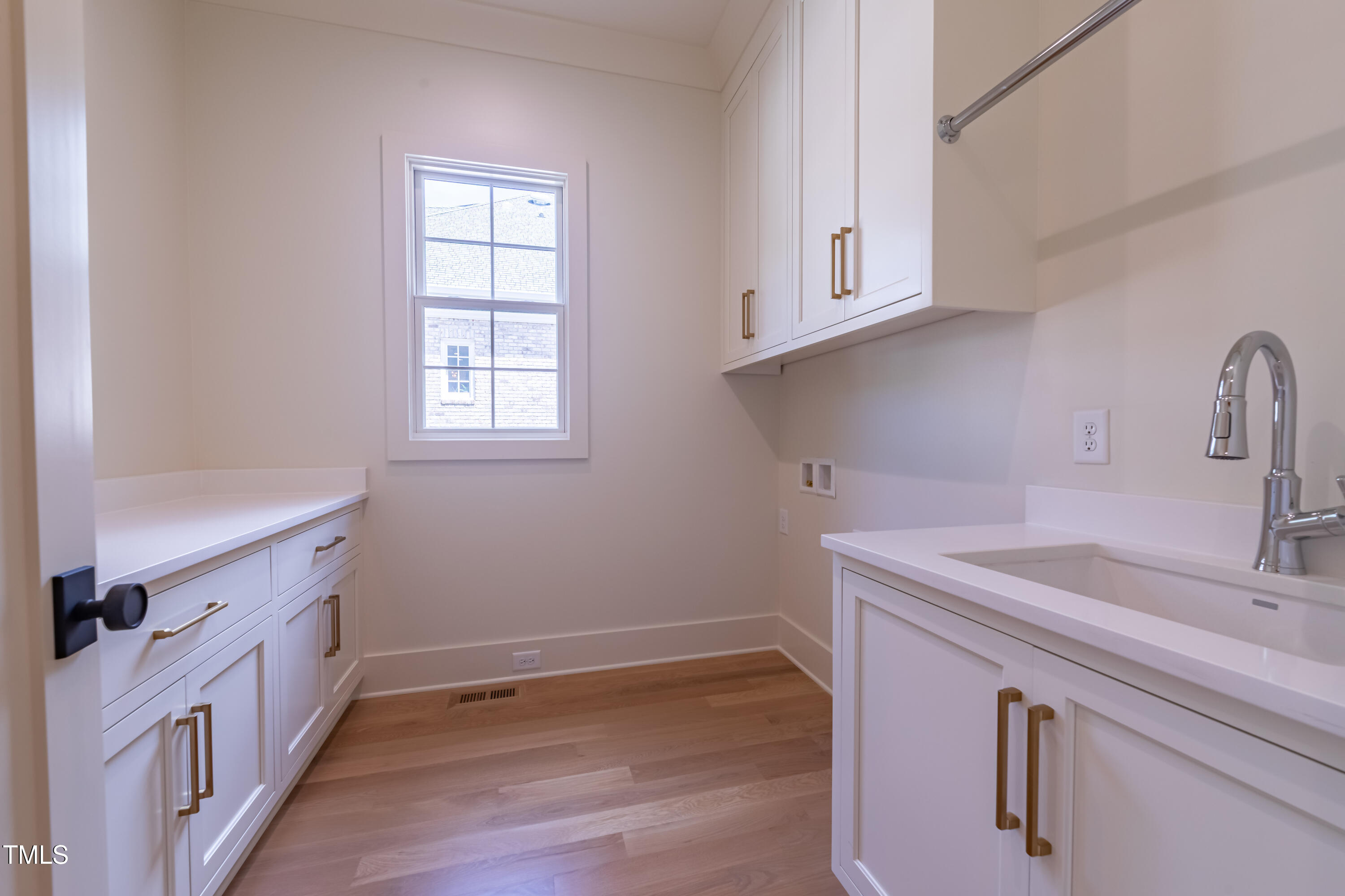 2227 Wheeler Road Raleigh, NC 27607 - Photo 30 of 56 a kitchen with sink cabinets and wooden floor