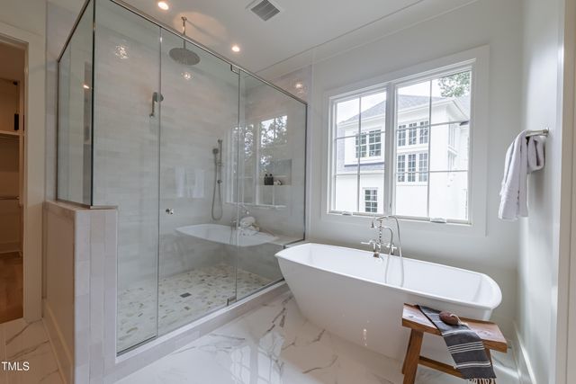 a bathroom with a granite countertop sink a toilet a mirror and bathtub