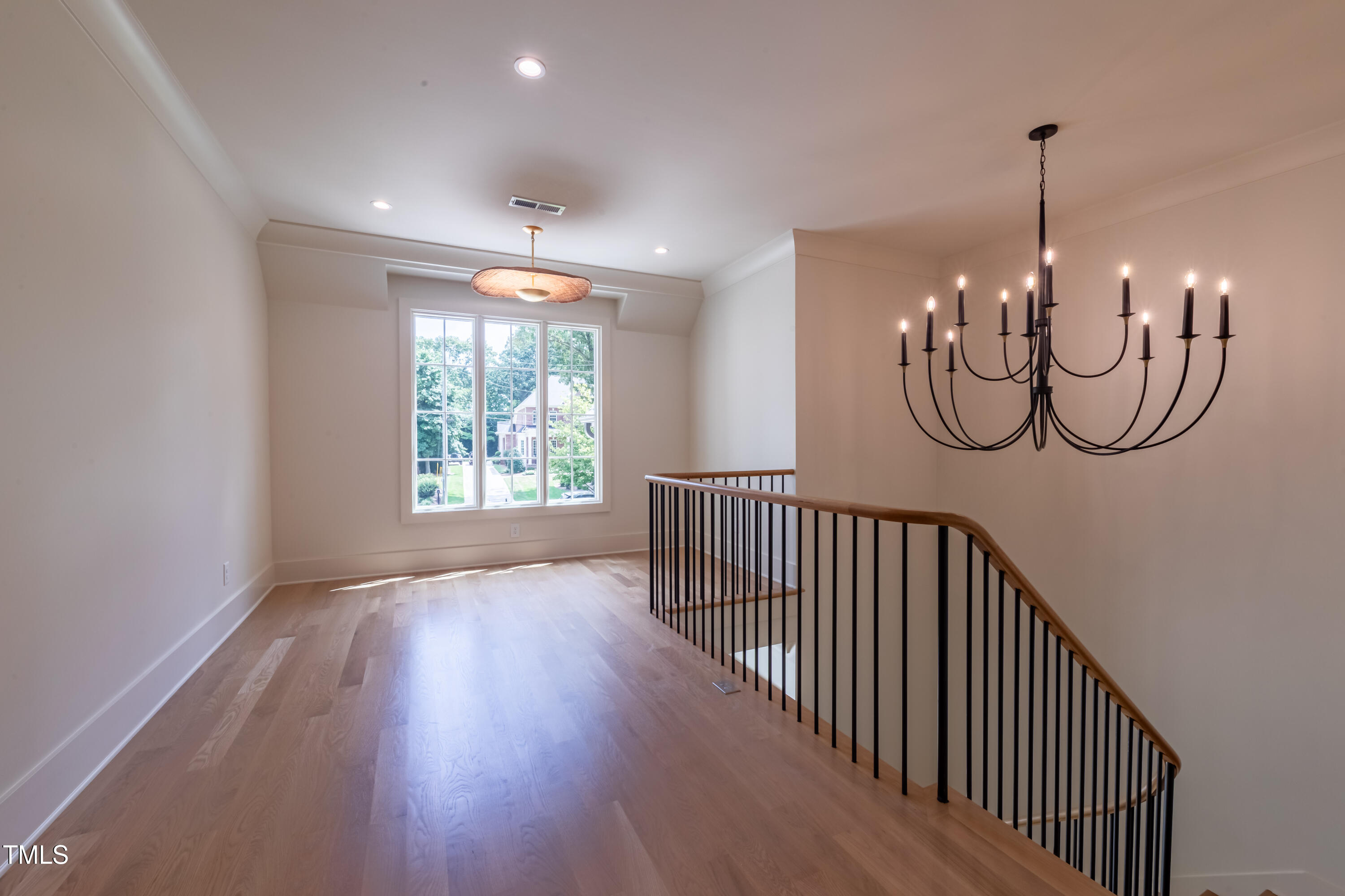 2227 Wheeler Road Raleigh, NC 27607 - Photo 40 of 56 a view of a hallway with wooden floor windows and stairs