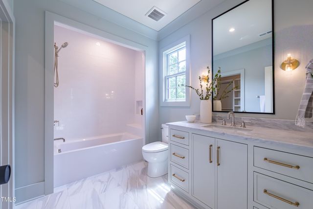 a bathroom with a sink toilet and mirror