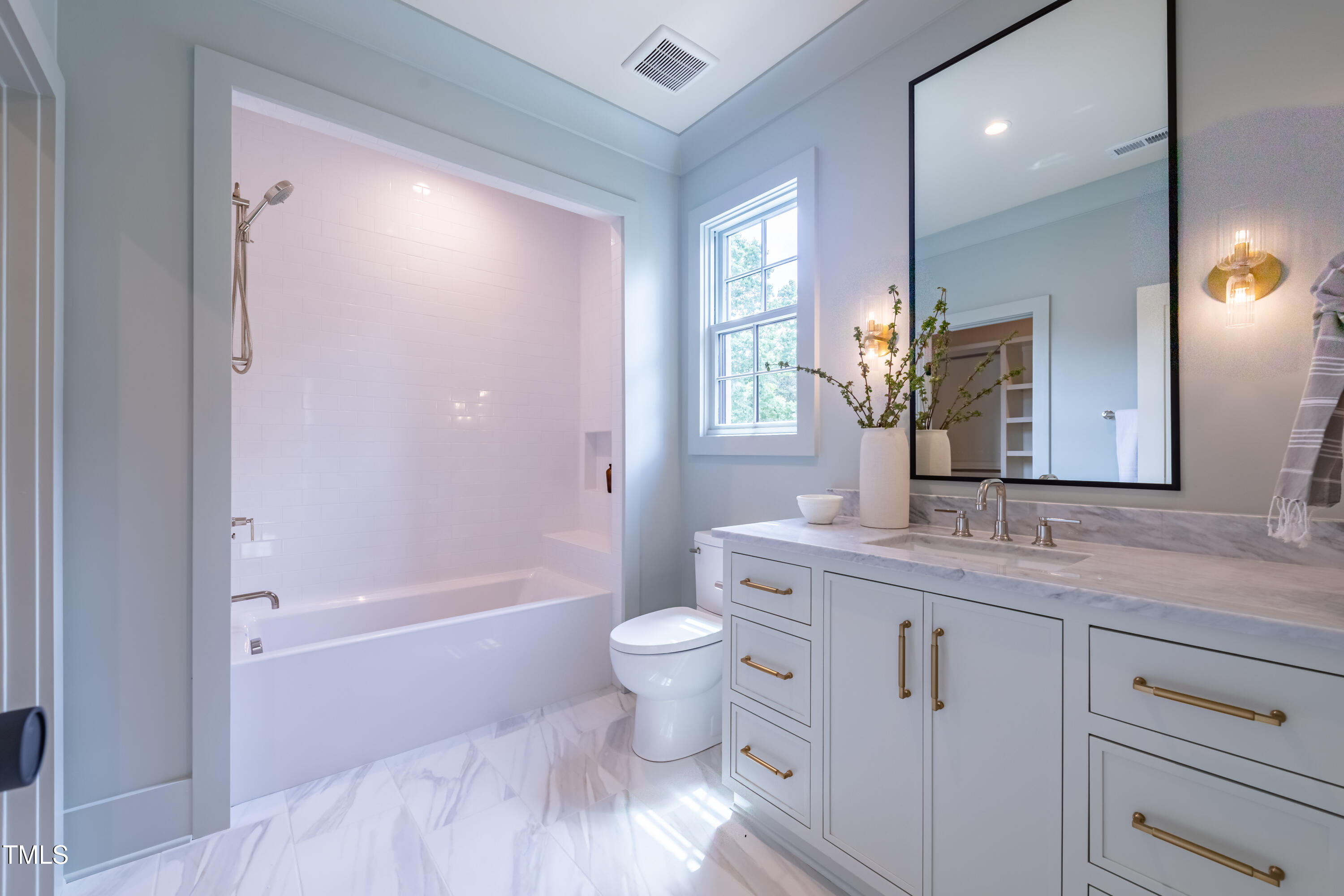 2227 Wheeler Road Raleigh, NC 27607 - Photo 41 of 56 a bathroom with a granite countertop sink a toilet a mirror and bathtub