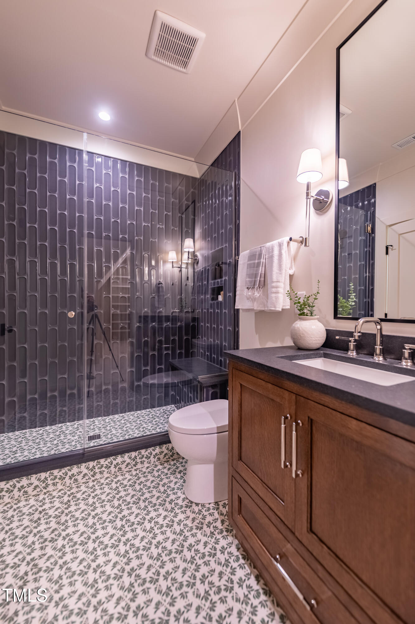 2227 Wheeler Road Raleigh, NC 27607 - Photo 44 of 56 a bathroom with a sink a toilet a mirror and shower