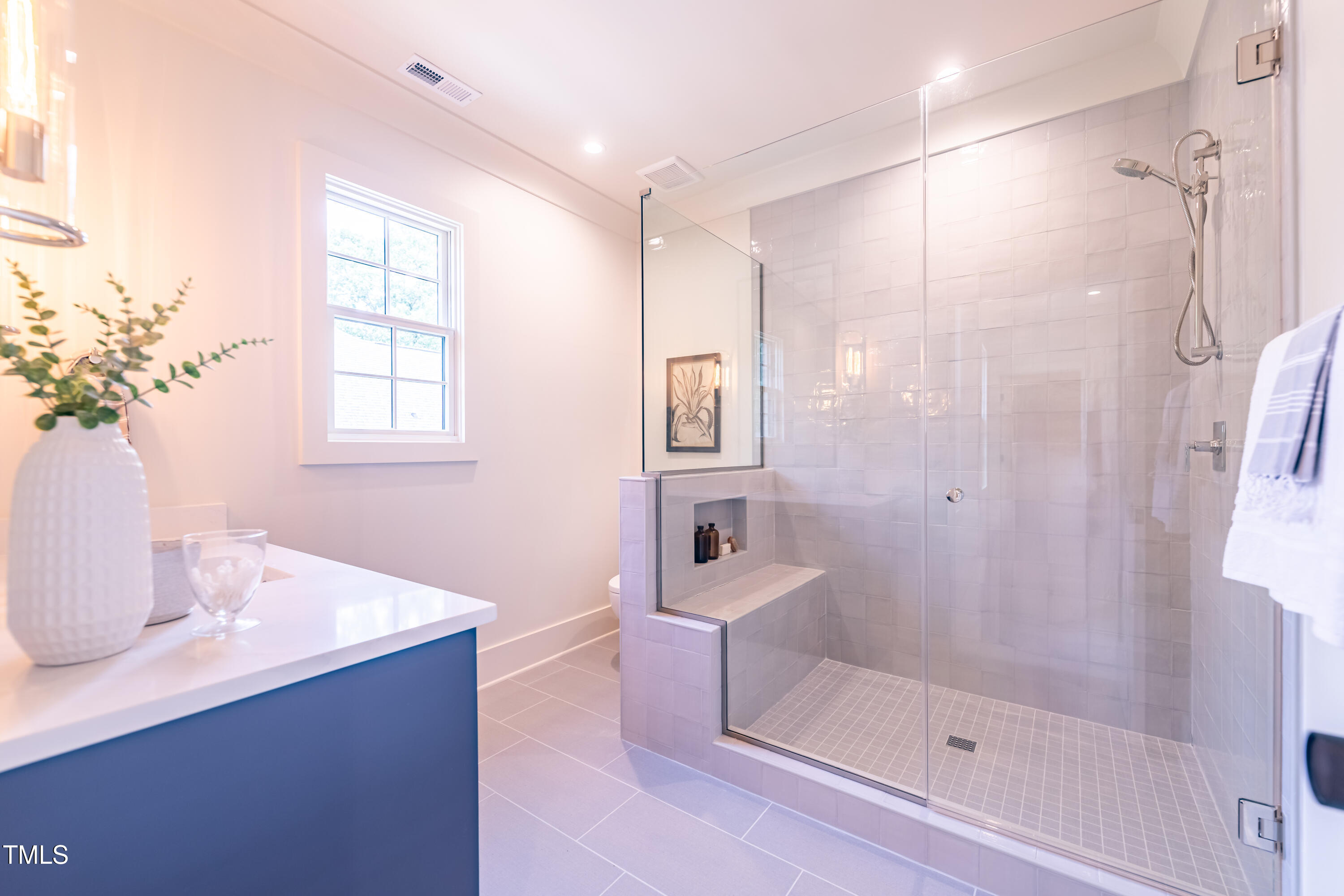 2227 Wheeler Road Raleigh, NC 27607 - Photo 45 of 56 a bathroom with a shower sink and mirror