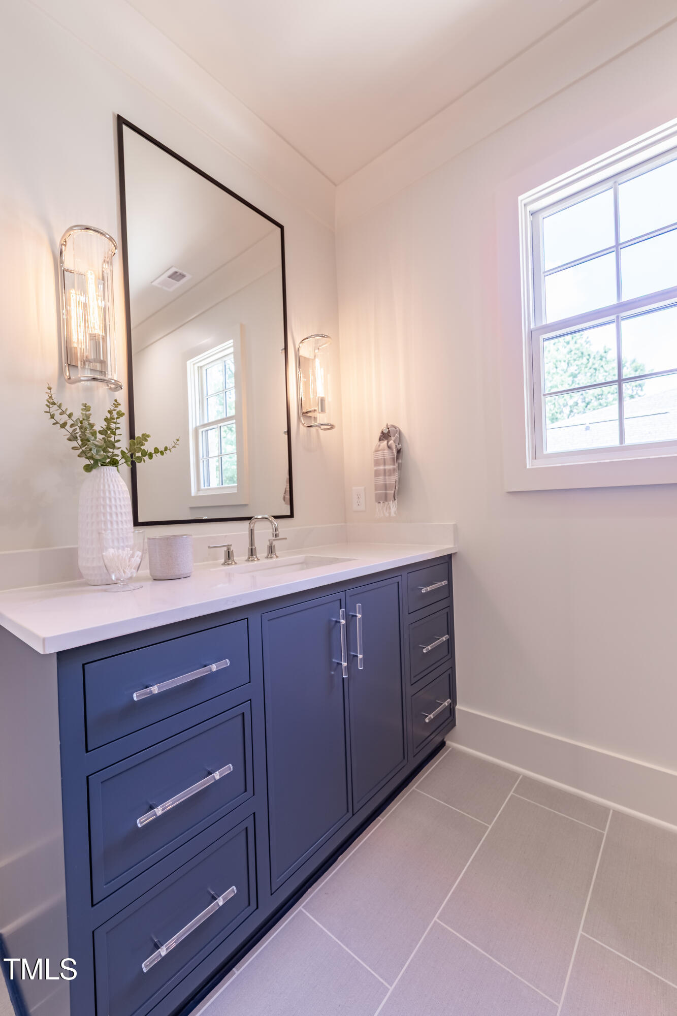 2227 Wheeler Road Raleigh, NC 27607 - Photo 46 of 56 a bath room with a sink and a mirror