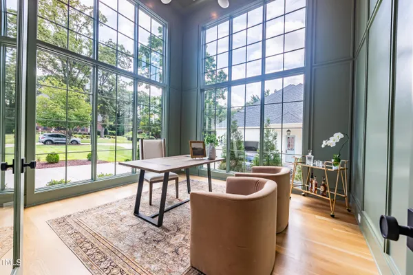a living room with furniture and a floor to ceiling window
