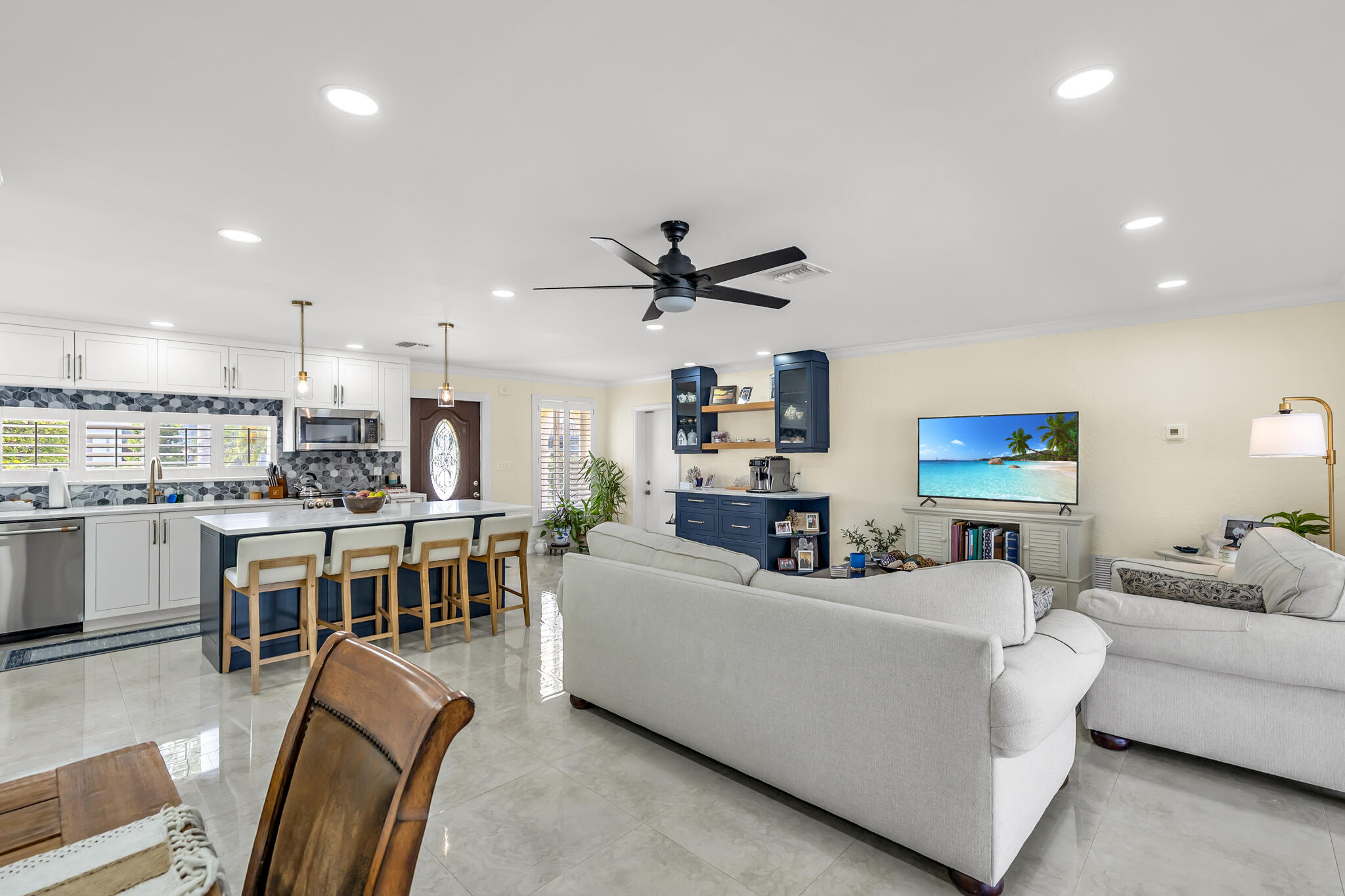 4920 Northeast 28th Avenue Lighthouse Point, FL 33064 - Photo 19 of 38 a living room with furniture kitchen view and a wooden floor