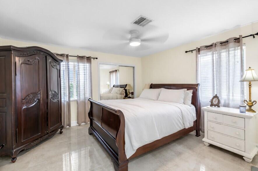 4920 Northeast 28th Avenue Lighthouse Point, FL 33064 - Photo 28 of 38 a spacious bedroom with a bed and a dresser