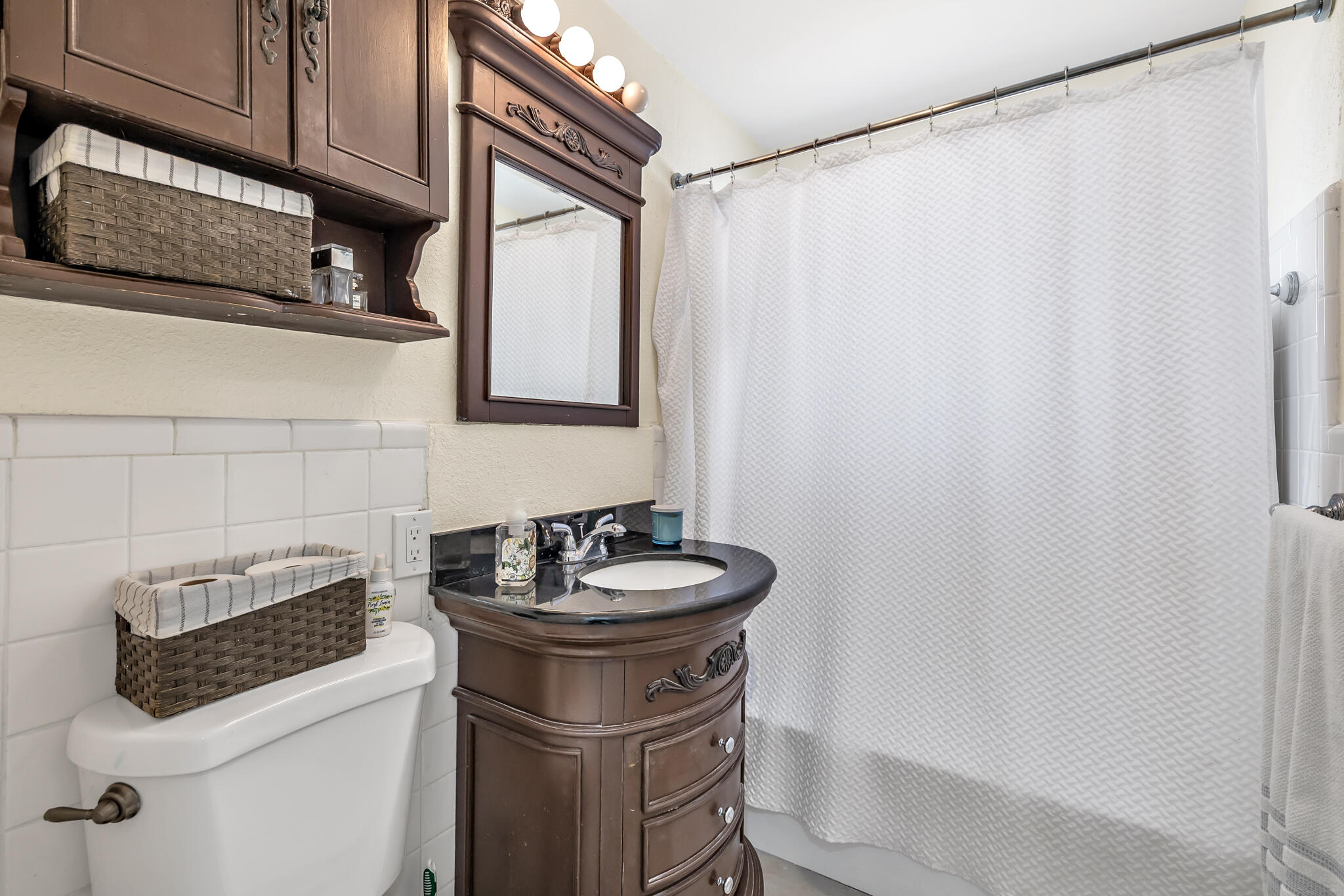 4920 Northeast 28th Avenue Lighthouse Point, FL 33064 - Photo 32 of 38 a bathroom with a sink and a mirror