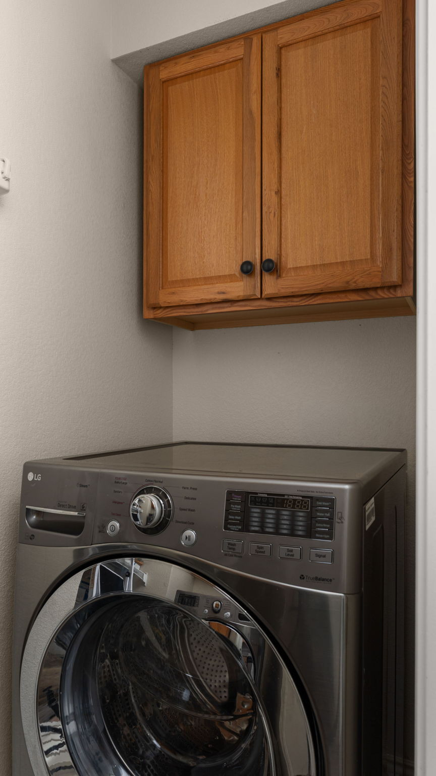 14815 Avery Ranch Boulevard, Unit 1401 Austin, TX 78717 - Photo 20 of 38 Wall-mounted wood cabinetry provides storage within this utility space