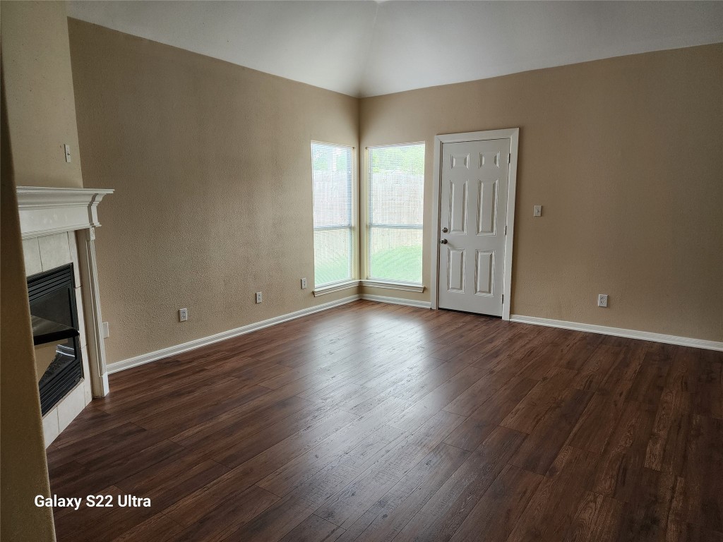 1926 Wavell Street Houston, TX 77088 - Photo 12 of 19 an empty room with wooden floor and windows