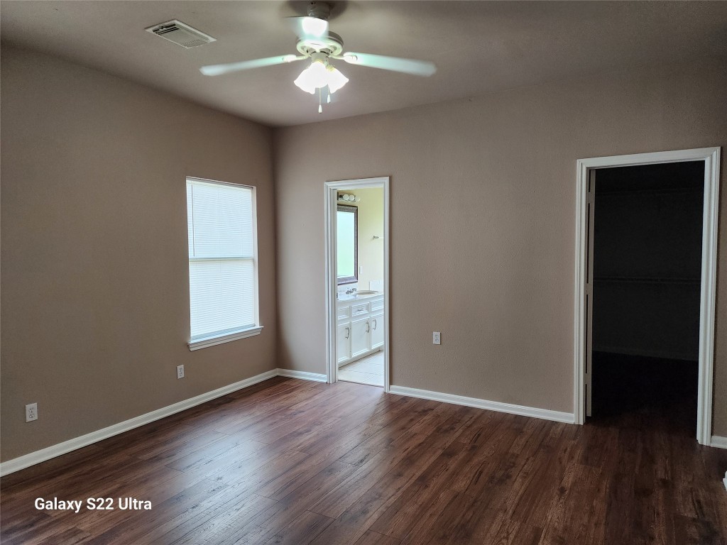 1926 Wavell Street Houston, TX 77088 - Photo 13 of 19 an empty room with wooden floor and windows