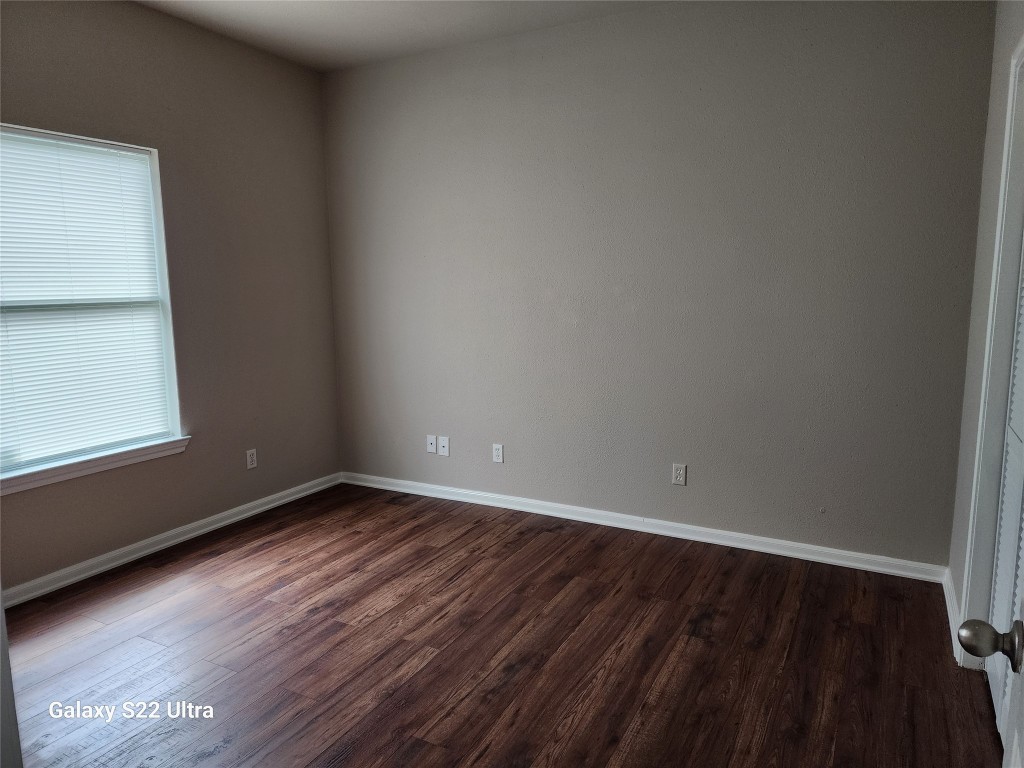 1926 Wavell Street Houston, TX 77088 - Photo 18 of 19 a view of an empty room with wooden floor and a window